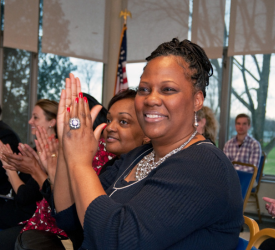 group of people clapping and smiling